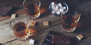 A tasting of different sweet whiskey brands with chocolate and marshmallow pairings.