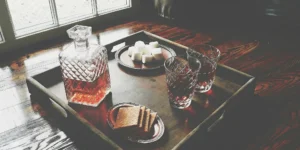 A unique whiskey gift set featuring a crystal decanter and a s'mores pairing.