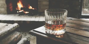 A glass of whiskey on a table, one of the best whiskey gifts for men.