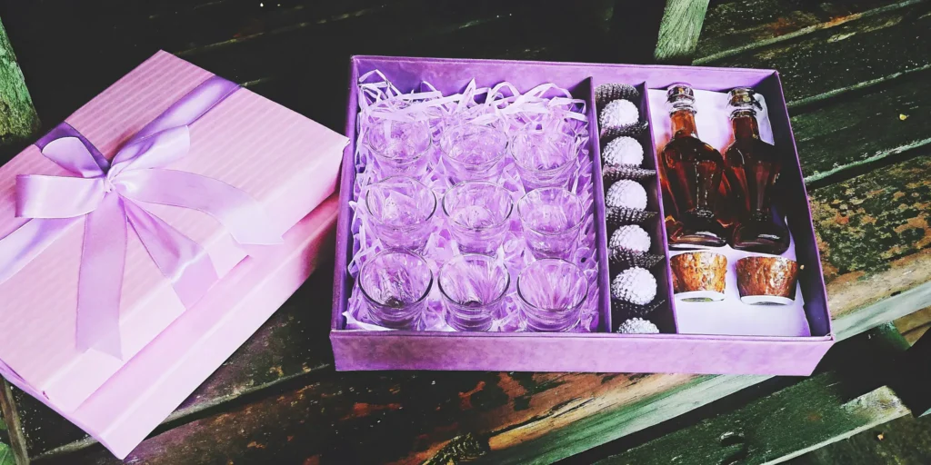 A unique bourbon gift set for him with whiskey glasses, mini bottles, and gourmet treats in a box.