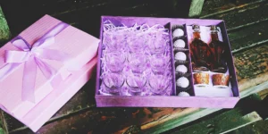 A unique bourbon gift set for him with whiskey glasses, mini bottles, and gourmet treats in a box.