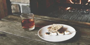 Toasted marshmallow whiskey in a rocks glass with garnish.