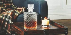 A cool whiskey gift idea featuring a crystal decanter filled with amber whiskey.