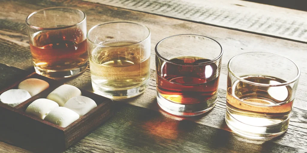 A flavored whiskey gift set with four tasting glasses and gourmet marshmallows.