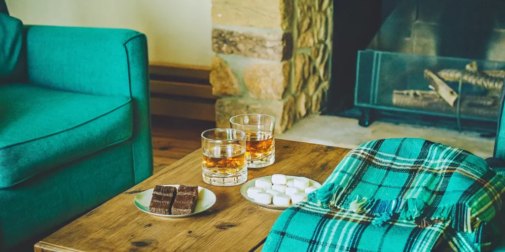 Flavored whiskey served by a fireplace, purchased from an online store with home delivery.