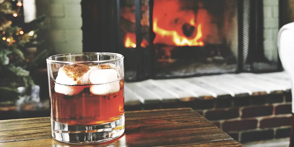 A glass of Mash & Mallow s'mores whiskey with toasted marshmallows, available to buy online.