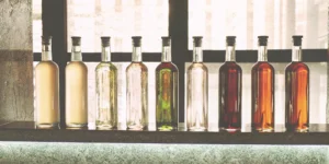 A diverse collection of craft flavored spirits displayed on a bar.