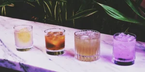 A variety of honey whiskey cocktail recipes in unique glasses with different garnishes.