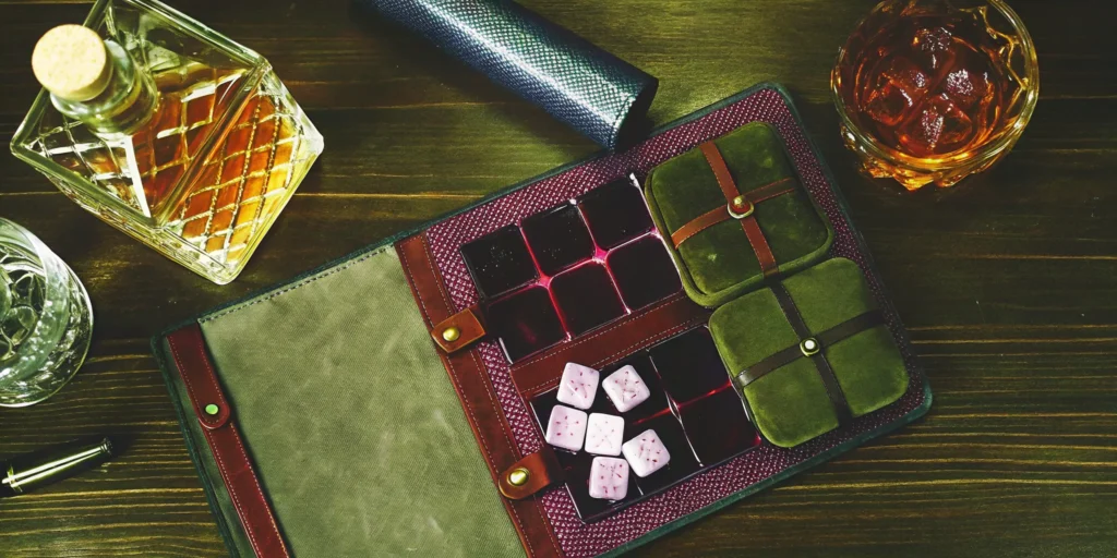 Unique whiskey gifts for guys, including a decanter, glass, and whiskey accessories.