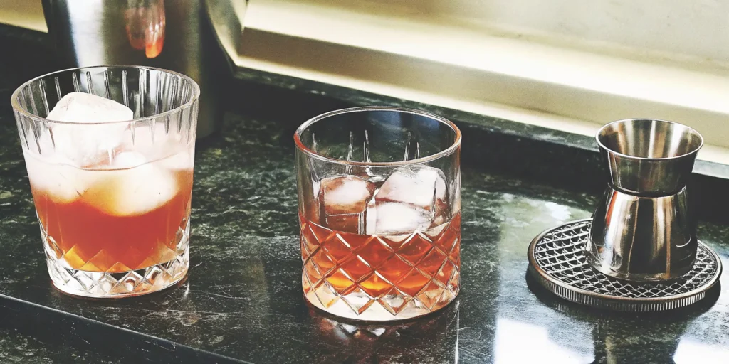 How to serve bourbon on the rocks in glasses with a jigger for measuring.