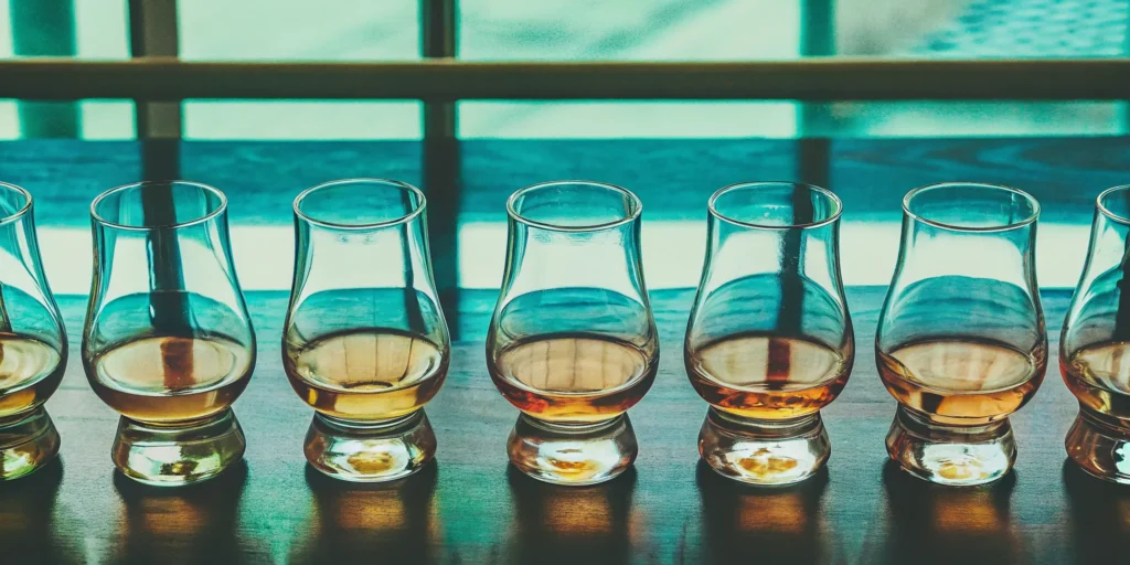 Several glasses of whiskey highlighting rich caramel notes.