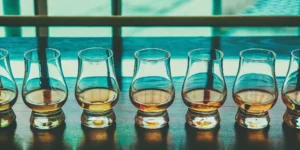 Several glasses of whiskey highlighting rich caramel notes.