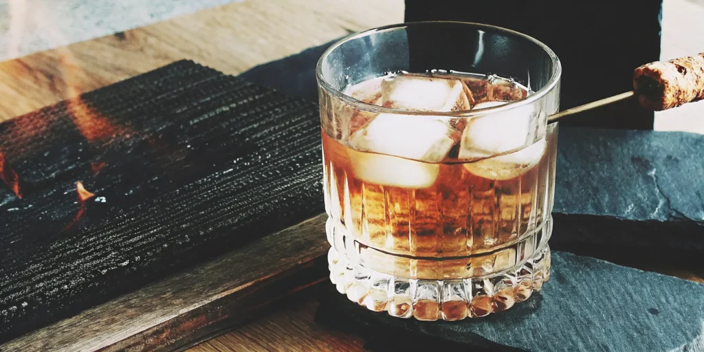 Toasted marshmallow bourbon cocktail from our recipe, with a toasted marshmallow garnish.